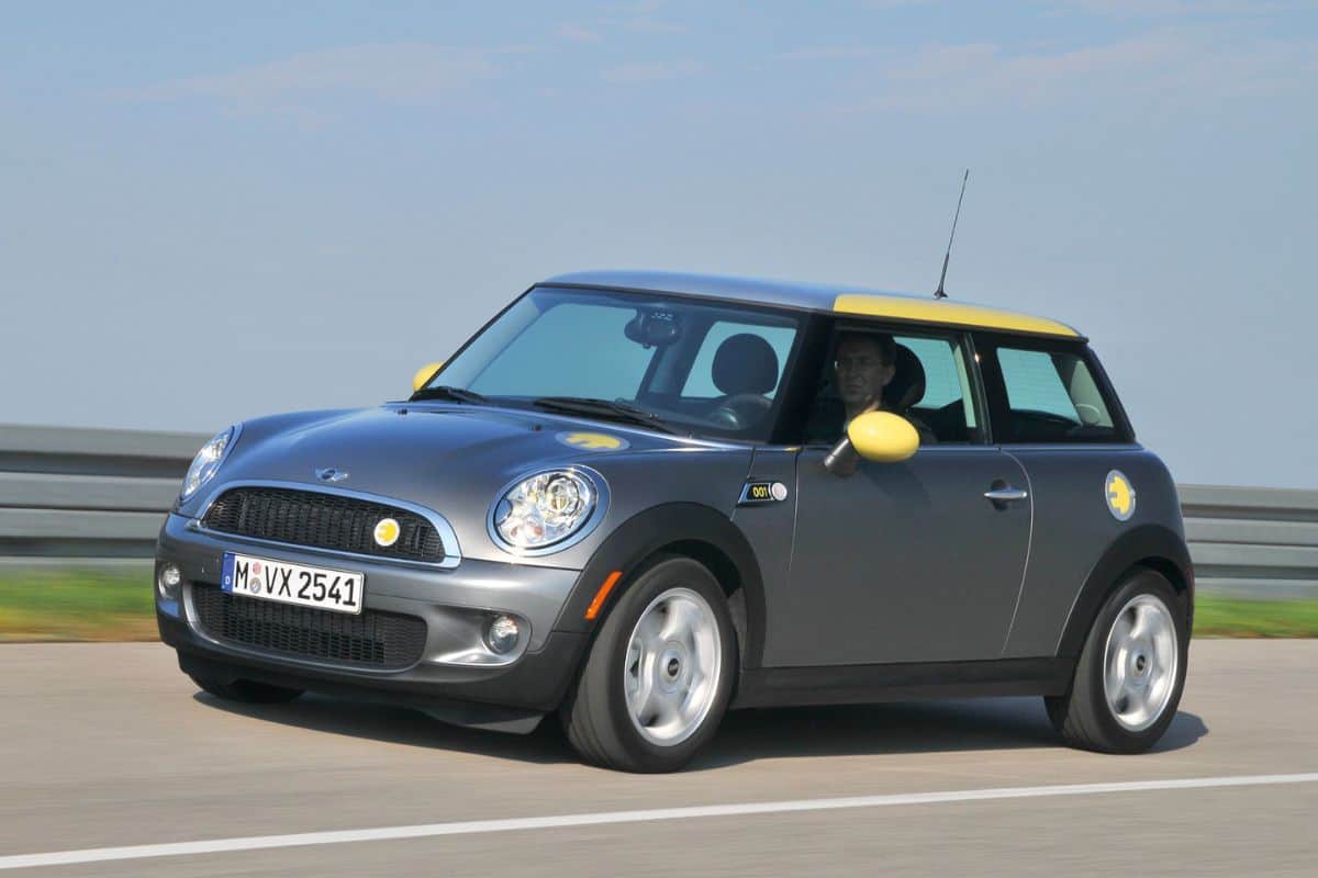 sillver and yellow Mini E driving on the highway