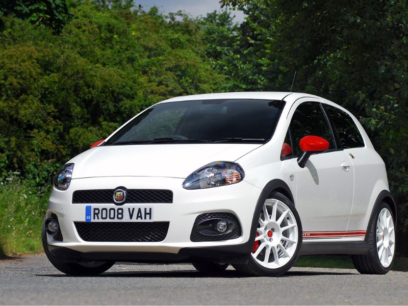 2009 Abarth Grande Punto Essseese in white and red with a forest backdrop